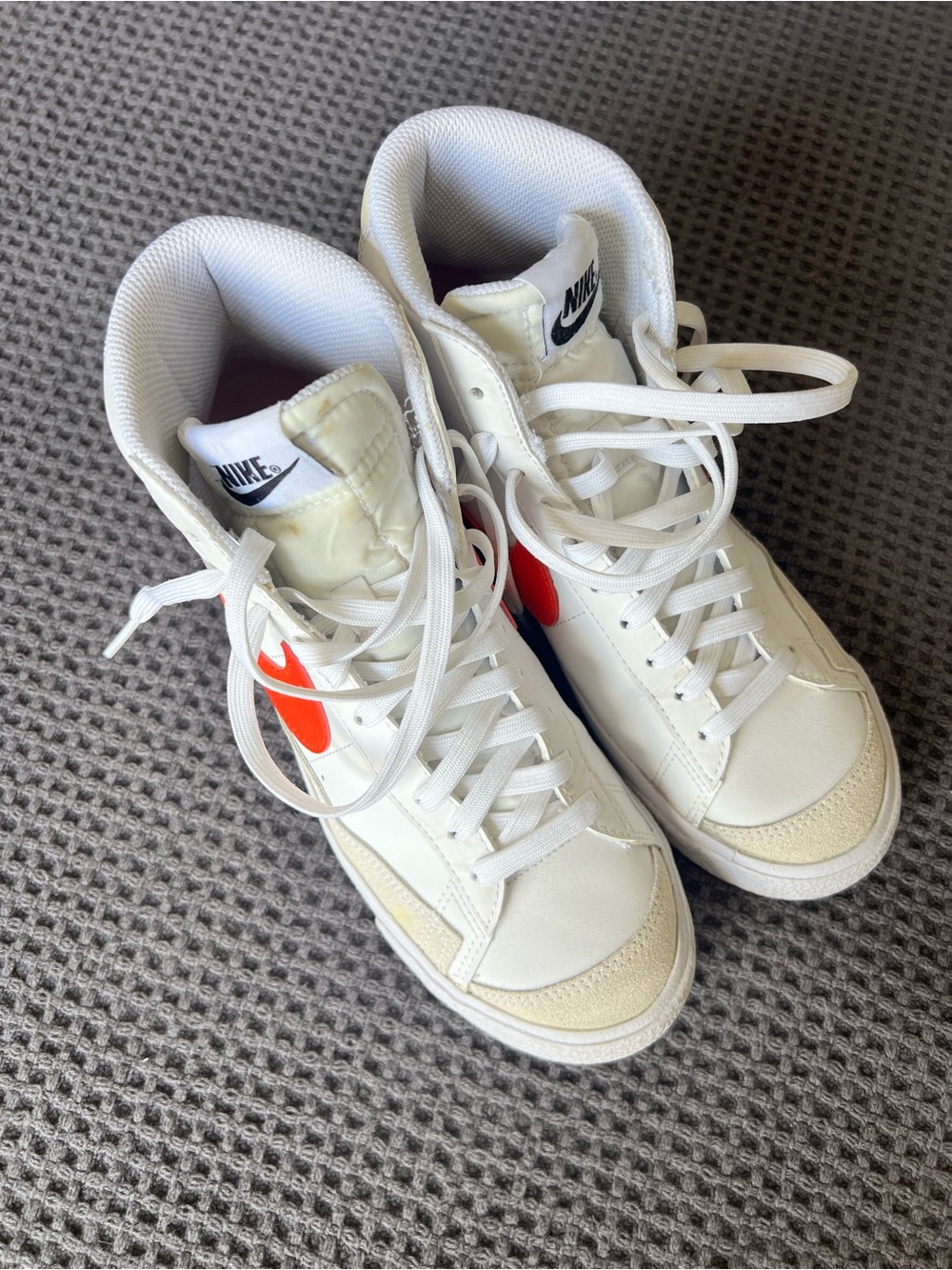 Nike White High-Top Sneakers with Bright Orange Swoosh